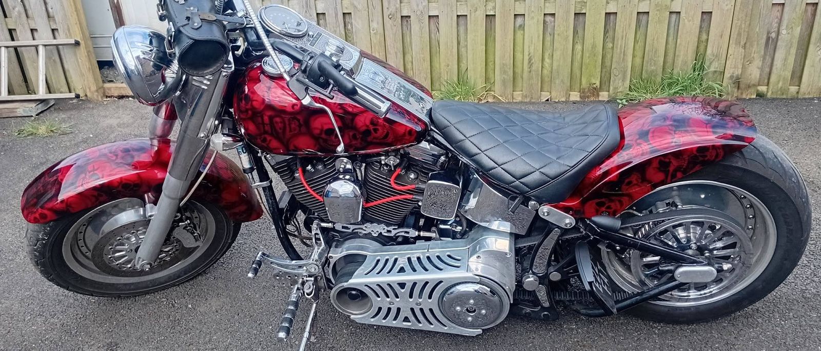 Harley-Davidson Softail with a full red and black skull airbrush finish