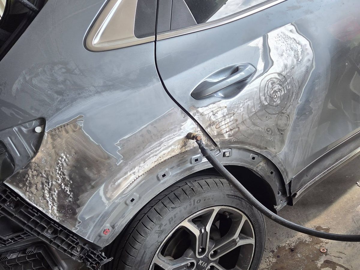 Rear quarter panel stripped back to bare metal during repair
